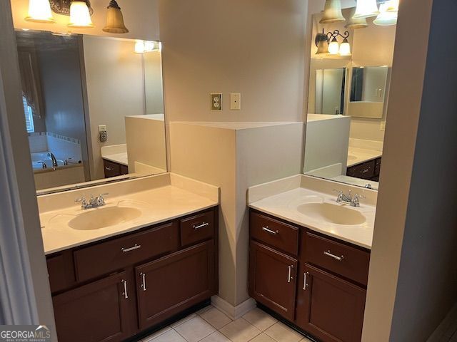 355 Tait Rd, Stockbridge, GA 30281 - bathroom featuring two vanities, tile patterned floors, and a garden tub