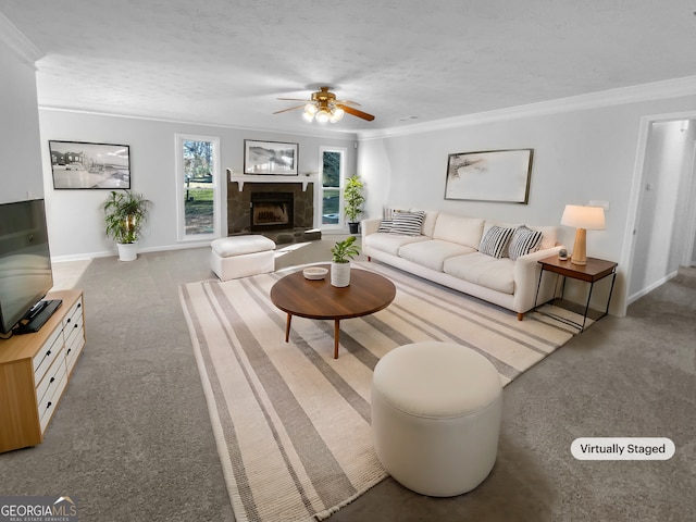 living room with light carpet, a textured ceiling, a fireplace with raised hearth, and crown molding