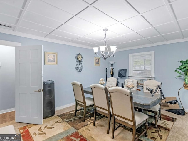 dining room featuring baseboards, visible vents, and a notable chandelier