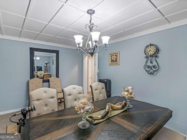 carpeted dining room featuring baseboards and a notable chandelier