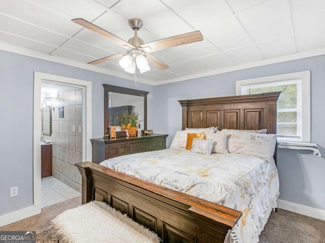 bedroom with a ceiling fan, baseboards, connected bathroom, and light colored carpet