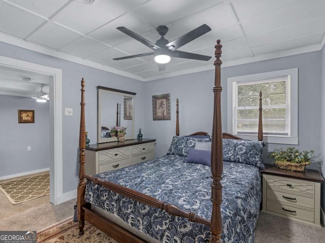 carpeted bedroom with a ceiling fan, a drop ceiling, crown molding, and baseboards