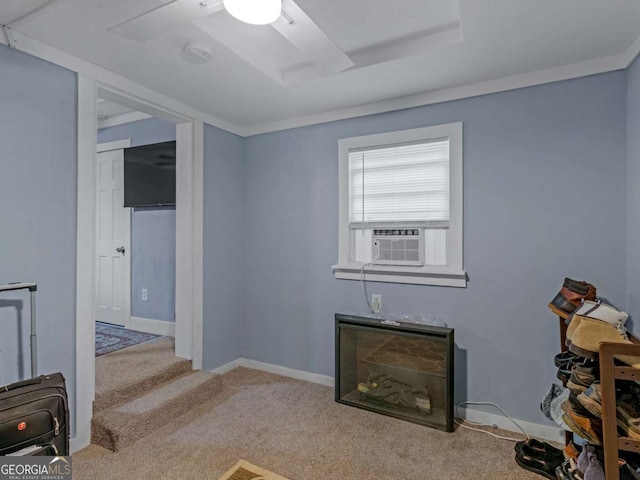 interior space with cooling unit, a tray ceiling, light colored carpet, and baseboards