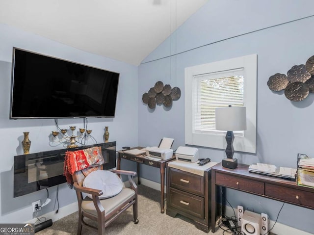 office space featuring vaulted ceiling and light colored carpet