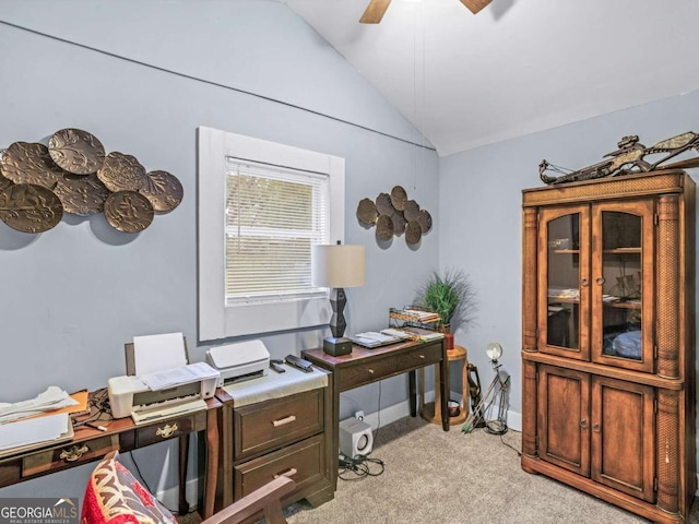 office featuring a ceiling fan, lofted ceiling, light colored carpet, and baseboards