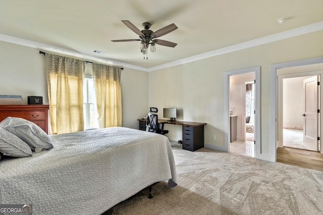 2634 Greenes Ln, Powder Springs, GA 30127 - carpeted bedroom featuring visible vents, ornamental molding, ensuite bathroom, a ceiling fan, and baseboards