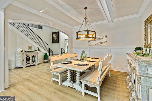 2634 Greenes Ln, Powder Springs, GA 30127 - dining space with beam ceiling, arched walkways, light wood finished floors, a chandelier, and stairs