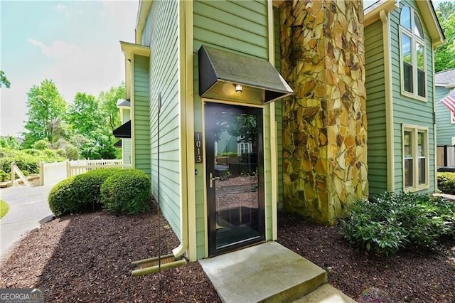 property entrance with fence