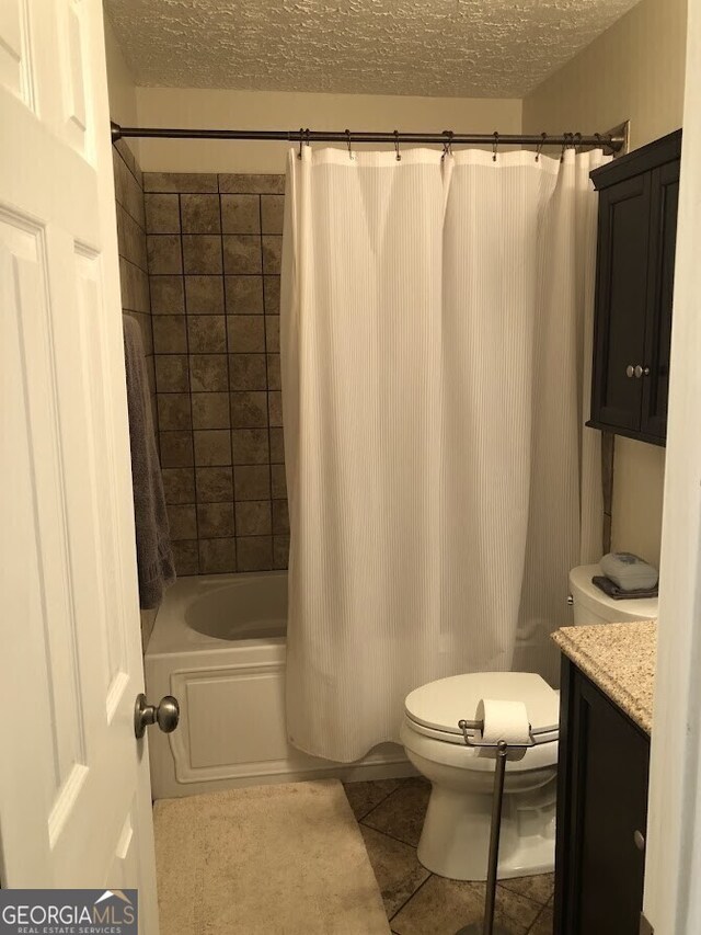 full bath with toilet, shower / bath combo with shower curtain, vanity, a textured ceiling, and tile patterned floors