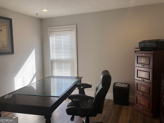 office area featuring a textured ceiling, baseboards, and dark wood-type flooring