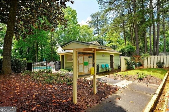 view of front of home featuring fence