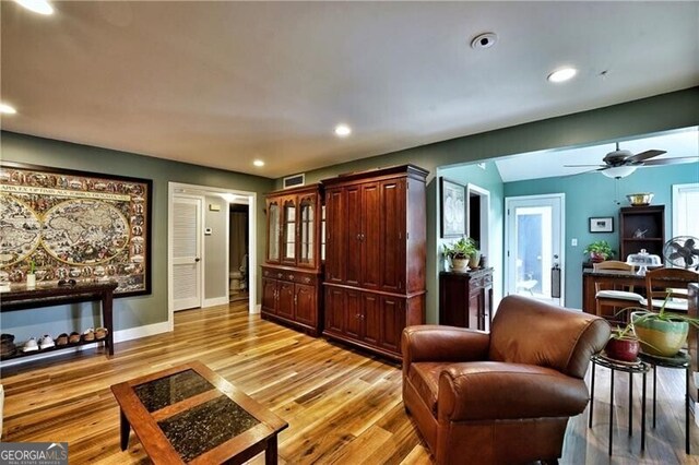 living area with recessed lighting, visible vents, baseboards, vaulted ceiling, and light wood finished floors