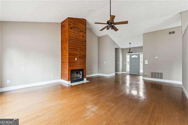 unfurnished living room with a fireplace, visible vents, and wood finished floors