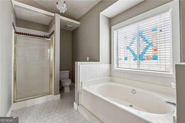 bathroom with a textured ceiling, toilet, a shower stall, a bath, and tile patterned floors