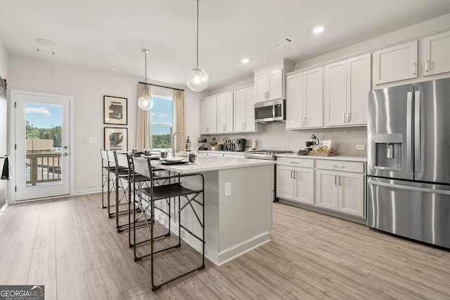 kitchen featuring white cabinetry, appliances with stainless steel finishes, and light countertops