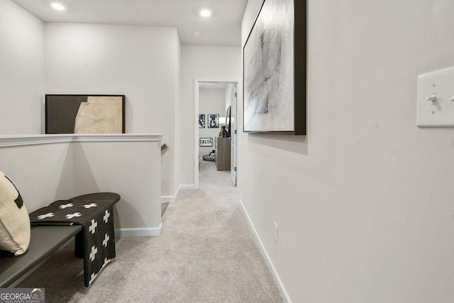 hall with light carpet, recessed lighting, baseboards, and an upstairs landing