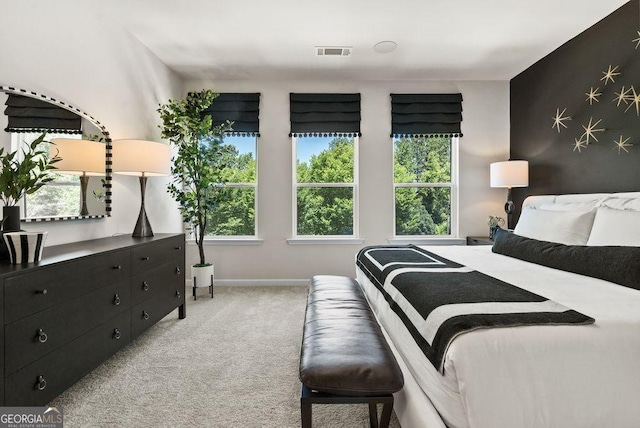 bedroom featuring light colored carpet, visible vents, and baseboards