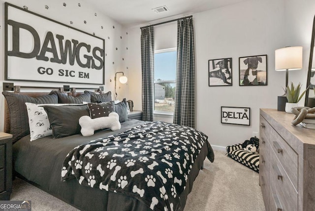 bedroom with visible vents, light carpet, and baseboards