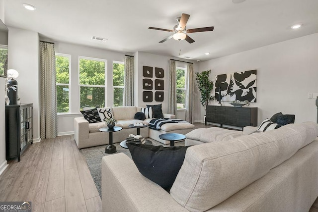 living area with recessed lighting, visible vents, a ceiling fan, light wood-type flooring, and baseboards