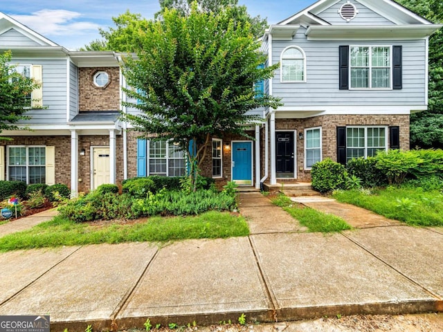 townhome / multi-family property with brick siding