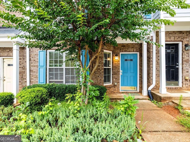 property entrance with brick siding