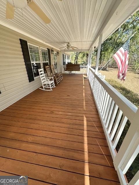 deck with covered porch and ceiling fan