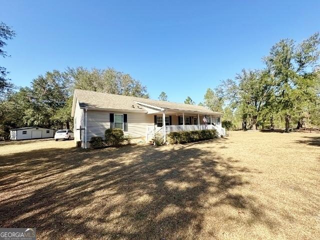 view of front facade with a porch and a front lawn