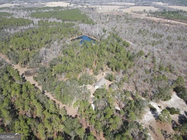 birds eye view of property with a view of trees