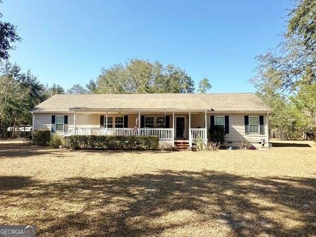 ranch-style home with crawl space, a porch, and a front yard