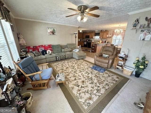 carpeted living room featuring a textured ceiling, crown molding, and ceiling fan with notable chandelier