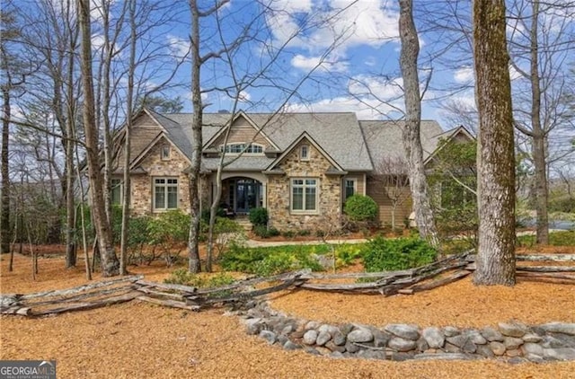 craftsman-style house featuring stone siding