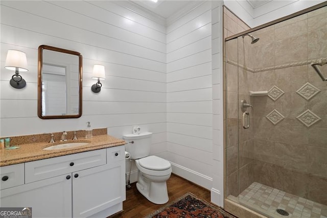 full bathroom with toilet, vanity, a shower stall, and wood finished floors