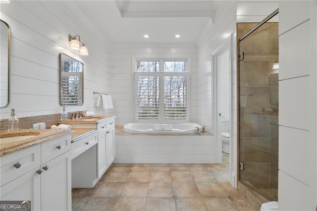 full bathroom with double vanity, a stall shower, toilet, ornamental molding, and a sink