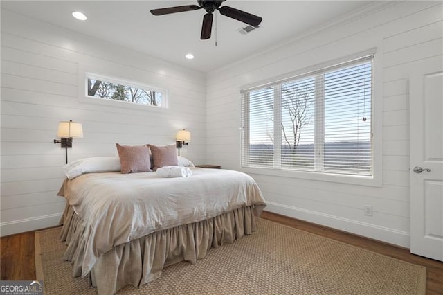 bedroom with visible vents, baseboards, wood finished floors, and recessed lighting