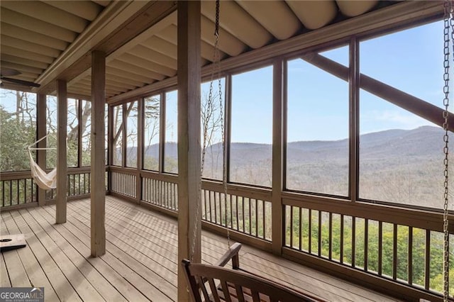 unfurnished sunroom featuring a mountain view