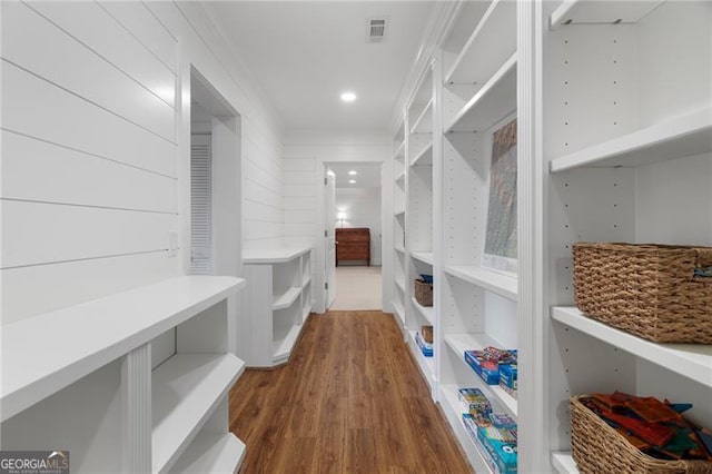 walk in closet featuring dark wood-style floors and visible vents