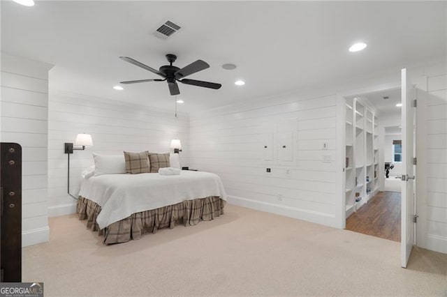 bedroom with light carpet, visible vents, and recessed lighting