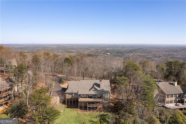 bird's eye view with a wooded view