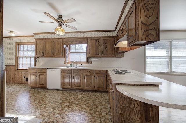 kitchen featuring wallpapered walls, white appliances, crown molding, and wainscoting