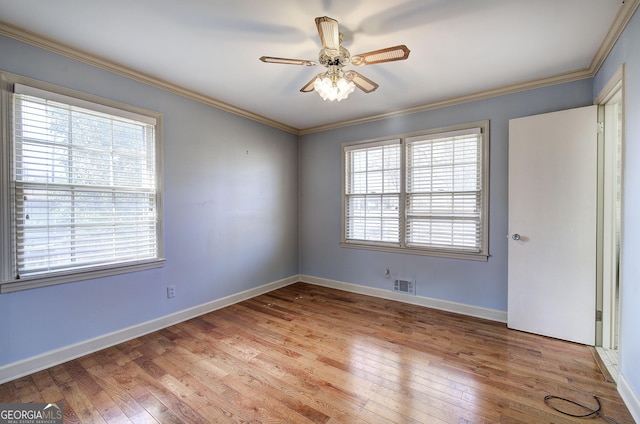 unfurnished room with light wood-style floors, baseboards, ornamental molding, and ceiling fan