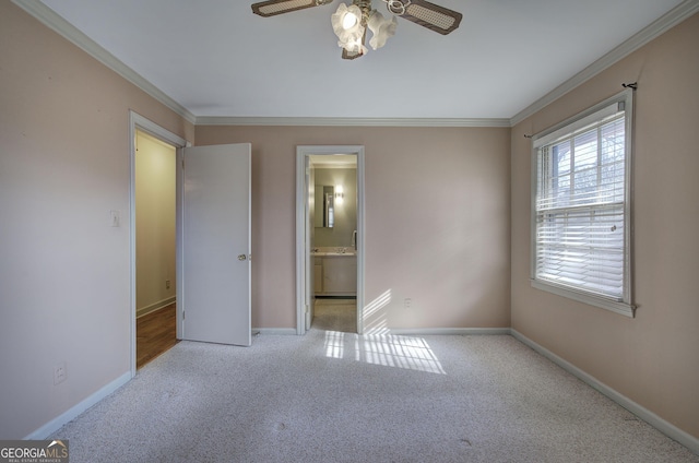 unfurnished bedroom with baseboards, ensuite bath, ceiling fan, ornamental molding, and carpet