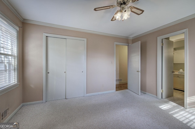 unfurnished bedroom featuring carpet floors, a closet, visible vents, and crown molding