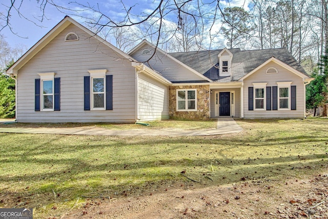 view of front of house with a front yard and stone siding