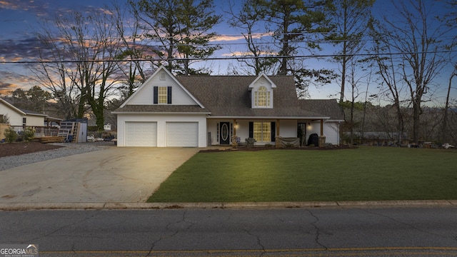 view of front facade with a garage, covered porch, a front lawn, and concrete driveway