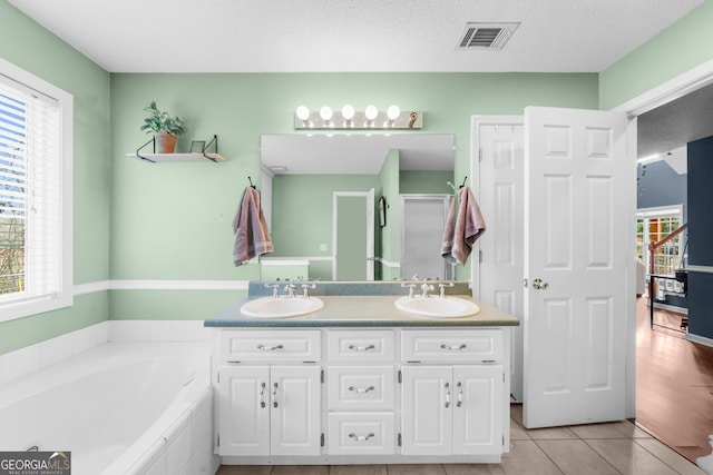 bathroom with visible vents, a sink, and a wealth of natural light