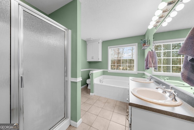 full bath with a stall shower, tile patterned flooring, a sink, and double vanity