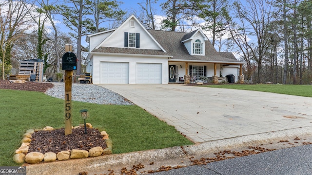 view of front of house featuring a garage, a front yard, concrete driveway, and a porch