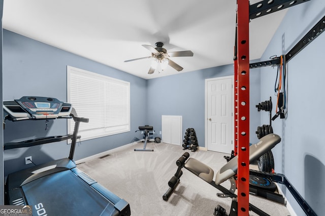 exercise room with baseboards, a ceiling fan, and carpet flooring