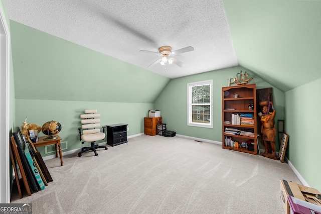 office space with lofted ceiling, carpet, a textured ceiling, and baseboards