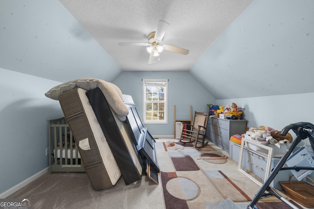 interior space with lofted ceiling, a textured ceiling, baseboards, and carpet flooring